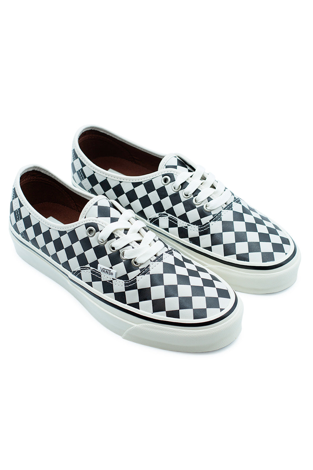 Vans LX Authentic 44 Diamond Check Black White skate shoes angled pair view highlighting textured checkerboard leather upper, low-top skate silhouette and vulcanized rubber sidewall