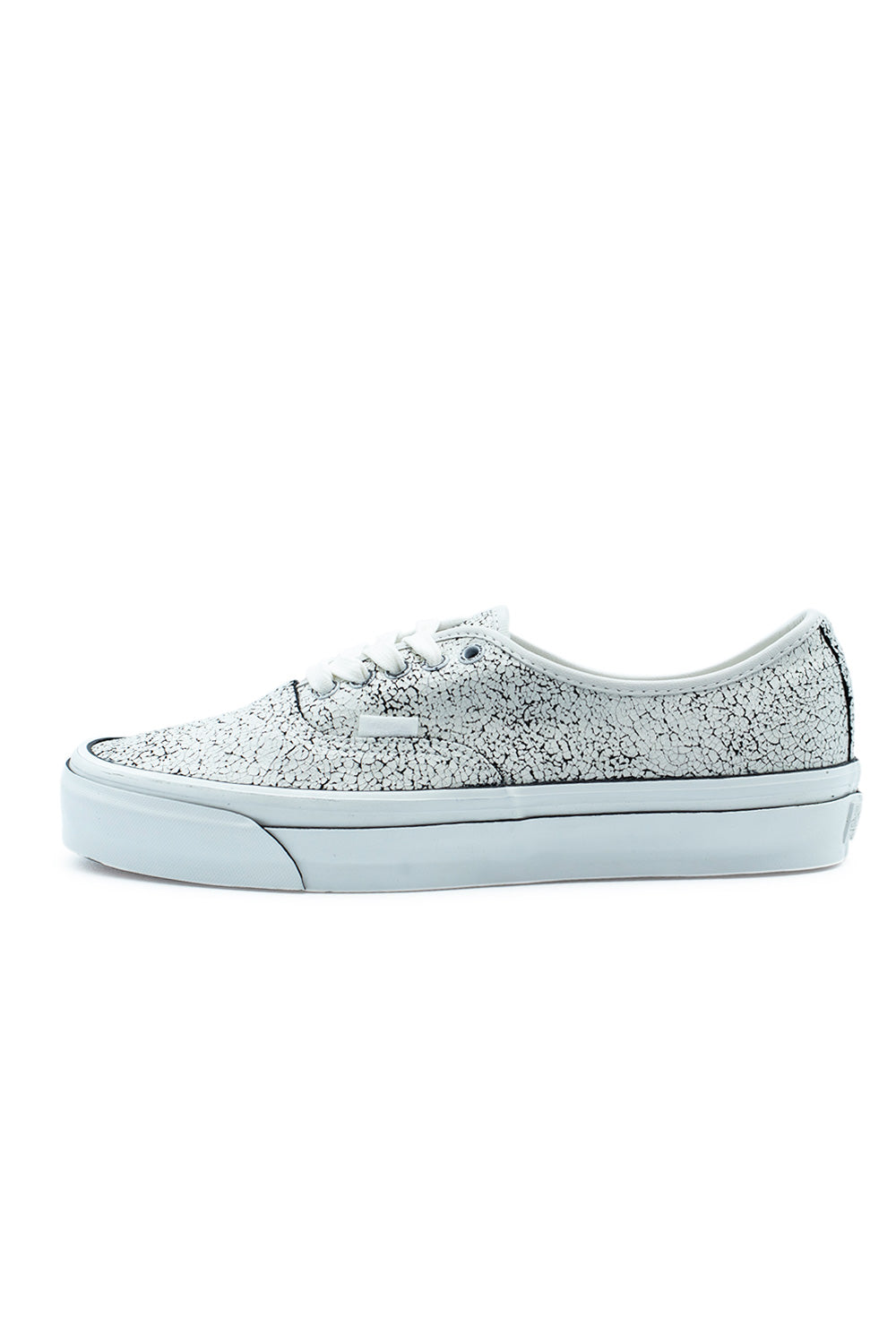 Lateral side profile of the Vans LX Authentic 44 sneaker in (Overpaint) Blanc De Blanc, displaying a dark suede upper coated with a white crackled overpaint design, white cotton laces, and a thick white vulcanized midsole with a thin black foxing line.