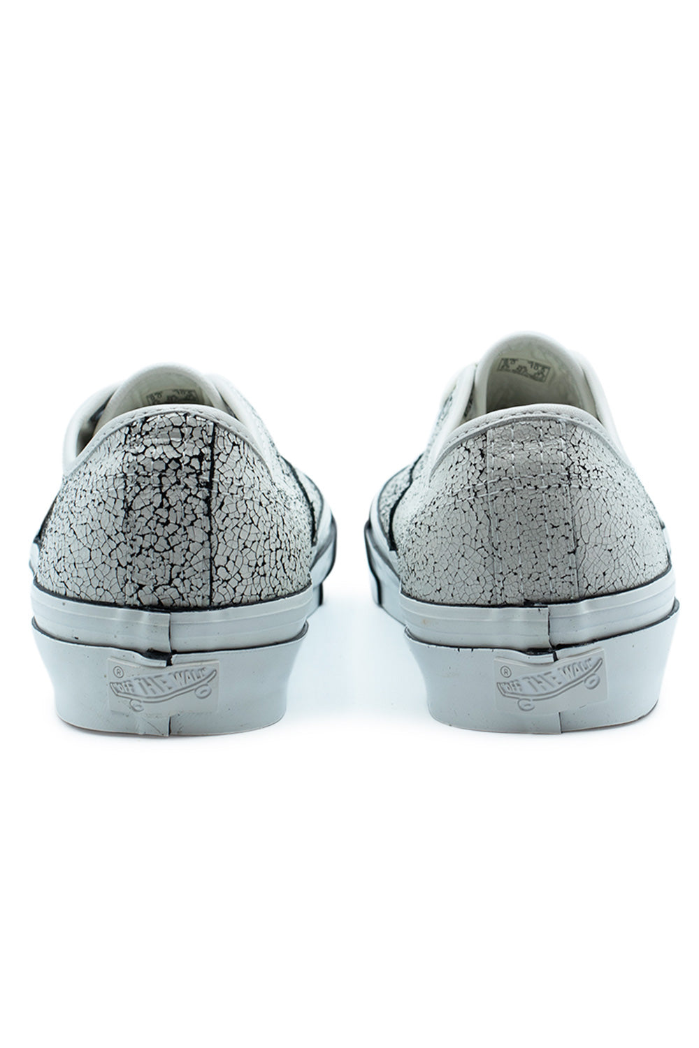 Rear heel view of the Vans LX Authentic 44 (Overpaint) Blanc De Blanc low-top shoes, highlighting the white-coated distressed crackle finish on the suede heel counter and the monochrome white Off The Wall rubber license plate patch on the glossy foxing tape.