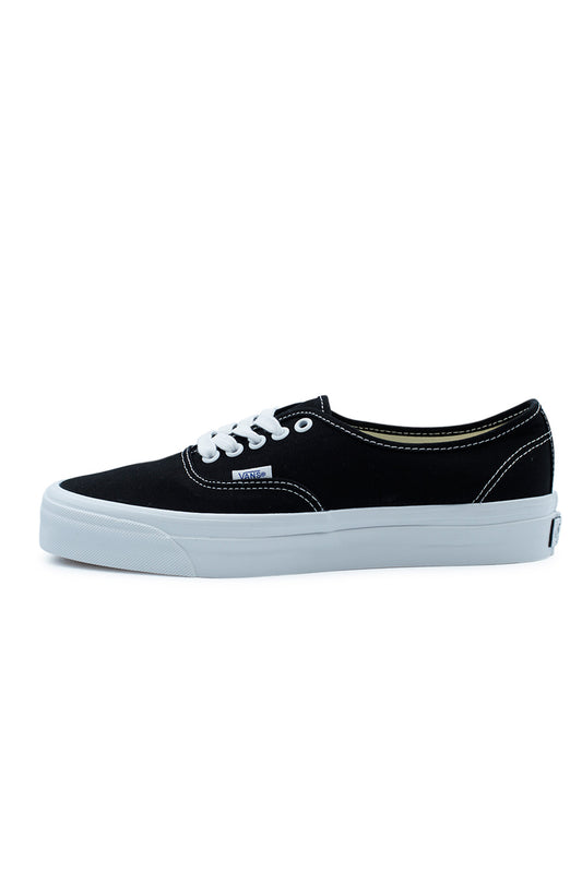 Side profile of the Vans LX Authentic Reissue 44 Shoe Black / White featuring a premium 226g black canvas upper, white rubber foxing with higher glossy sidewall, archival low-top silhouette, contrast stitching and the classic Vans waffle sole inspired by the original 1966 Style 44 skate shoe.