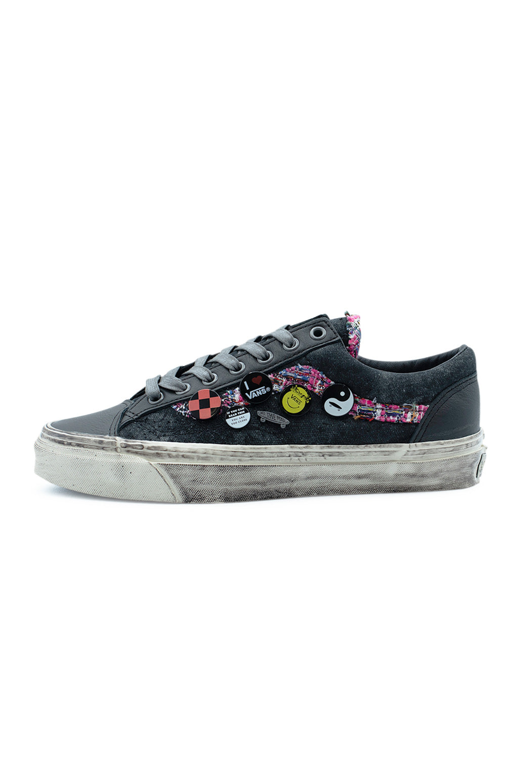 Lateral side profile of the Vans LX Old Skool 36 (Souvenir) Faded Black shoe, showcasing a distressed sprayed canvas upper decorated with colorful removable metal pins, a multi-colored woven tweed Sidestripe, and a dirty vintage-treated vulcanized midsole.