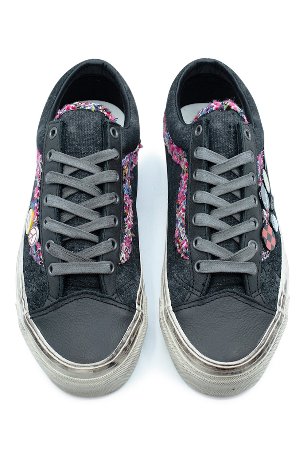 Top-down perspective of a pair of Vans LX Old Skool 36 Souvenir Faded Black sneakers, highlighting the dark full-grain leather toe caps, charcoal grey laces, frayed tweed lining on the tongue, and custom pin details on the lateral eyestays.