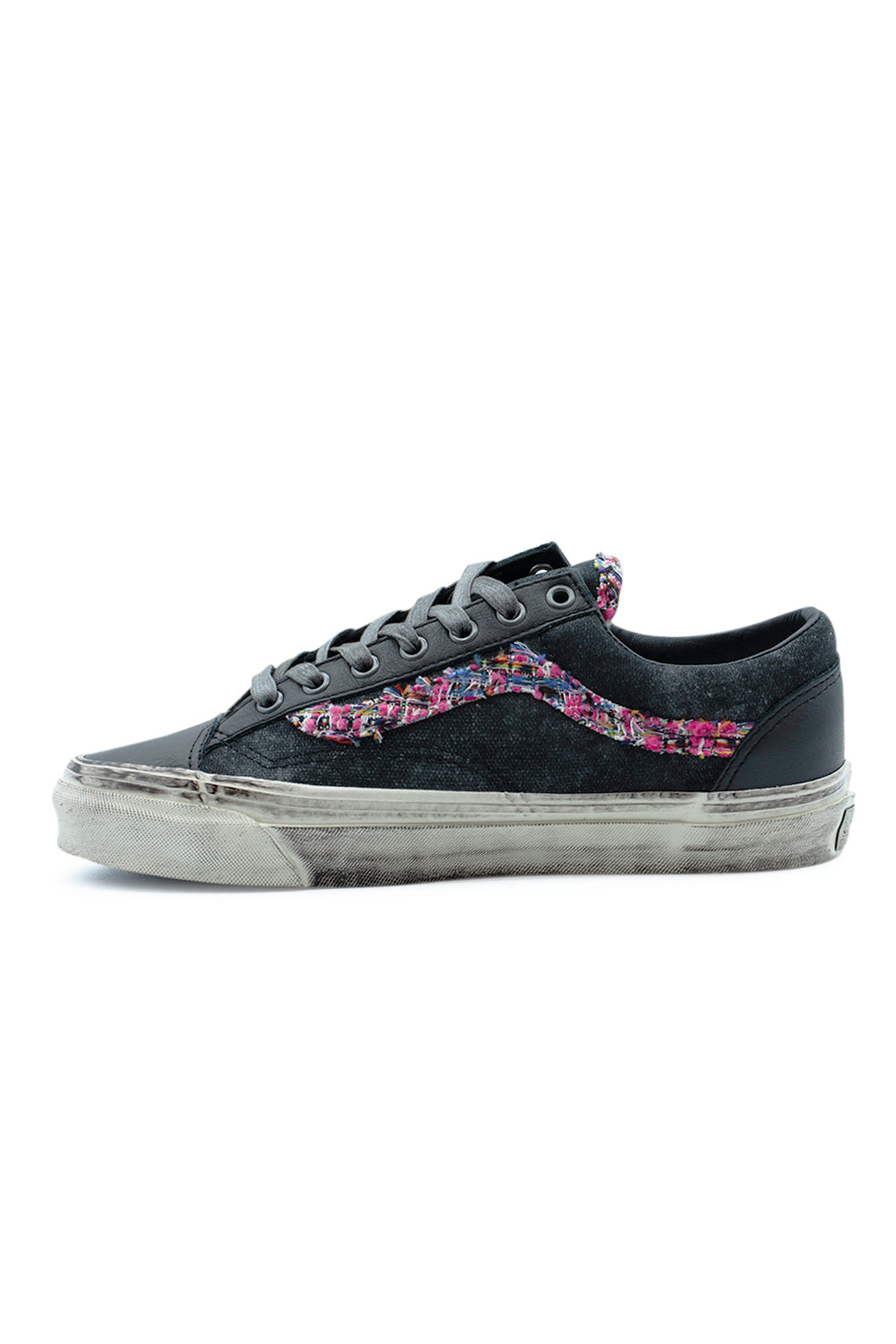 Medial side profile view of the Vans LX Old Skool 36 Souvenir shoe, illustrating the clean spray-painted washed black canvas panel without pins, the vibrant multi-color tweed Sidestripe, and the heavily weathered vulcanized sidewall.