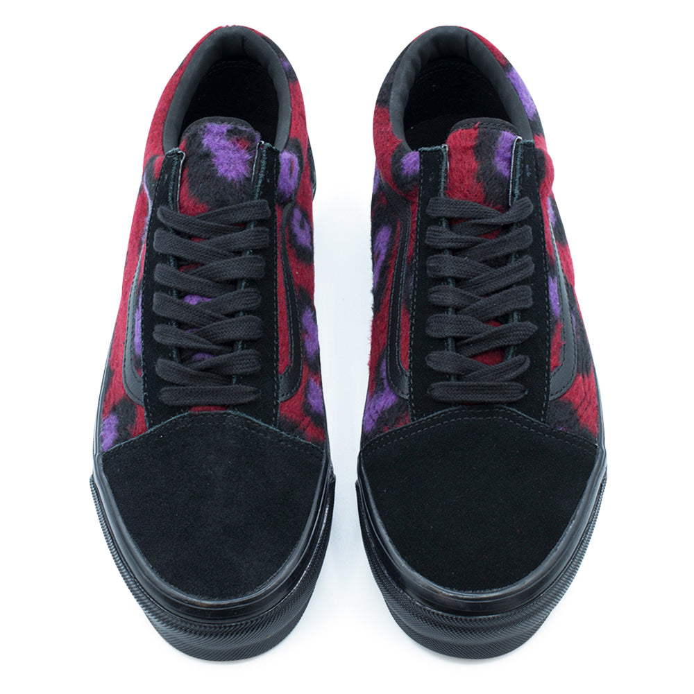 Top-down studio shot of the Vans LX Old Skool Leopard pair, detailing the velvety black suede toe caps, flat black cotton laces, fuzzy multi-colored leopard print tongues, black leather collar linings, and glossy vulcanized rubber toe bumpers.