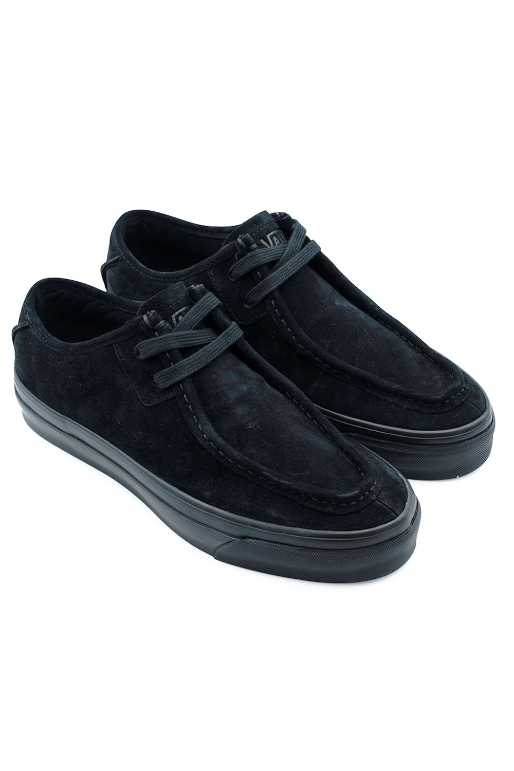 Elevated three-quarter perspective studio shot of the Vans LX SF Moc Low in monochrome black suede, detailing the boat shoe-inspired moccasin toe profile, internal bio-based Sola Foam ADC cushioning, and low-top vulcanized skate build.