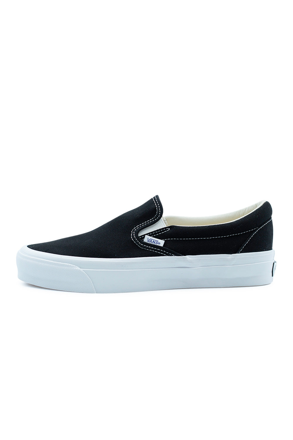 Vans LX Slip-On Reissue 98 Black White premium skate shoe side view featuring classic Style 98 silhouette, black canvas upper and vulcanized rubber sole with signature Vans sidewall