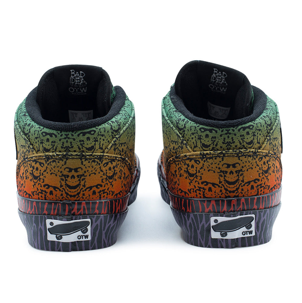 Rear studio perspective of the Vans OTW x Chito Half Cab 33 heels, displaying the padded collar with black mesh lining, inner tongue woven tags, gradient canvas back panel covered in detailed skull artwork, and black rubber heel counters printed with purple tribal lines and centered with black-and-white "Vans OTW" skateboard license plates.