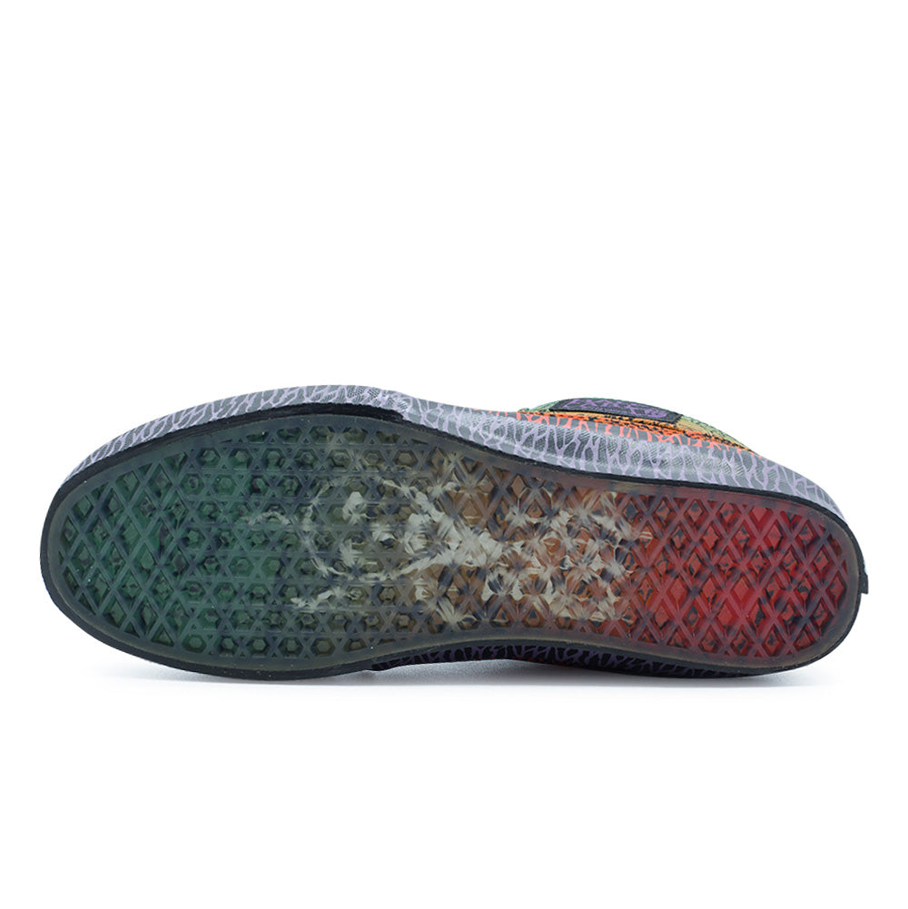 Full bottom studio flat lay of the Vans OTW x Chito Half Cab 33 outsole, featuring a translucent clear gum rubber waffle traction tread revealing Chito's colorful airbrush skull graphic underneath, bordered by purple-printed black foxing sidewalls.