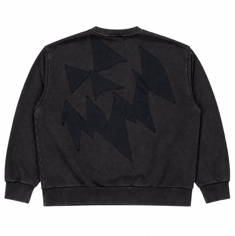 Back flat lay studio view of the Vans OTW x Chito Sweatshirt in washed vintage black, showcasing a relaxed heavyweight crewneck silhouette centered by an expansive tonal black canvas applique patch cut into sharp jagged and triangular geometric artwork designed by artist Chito.