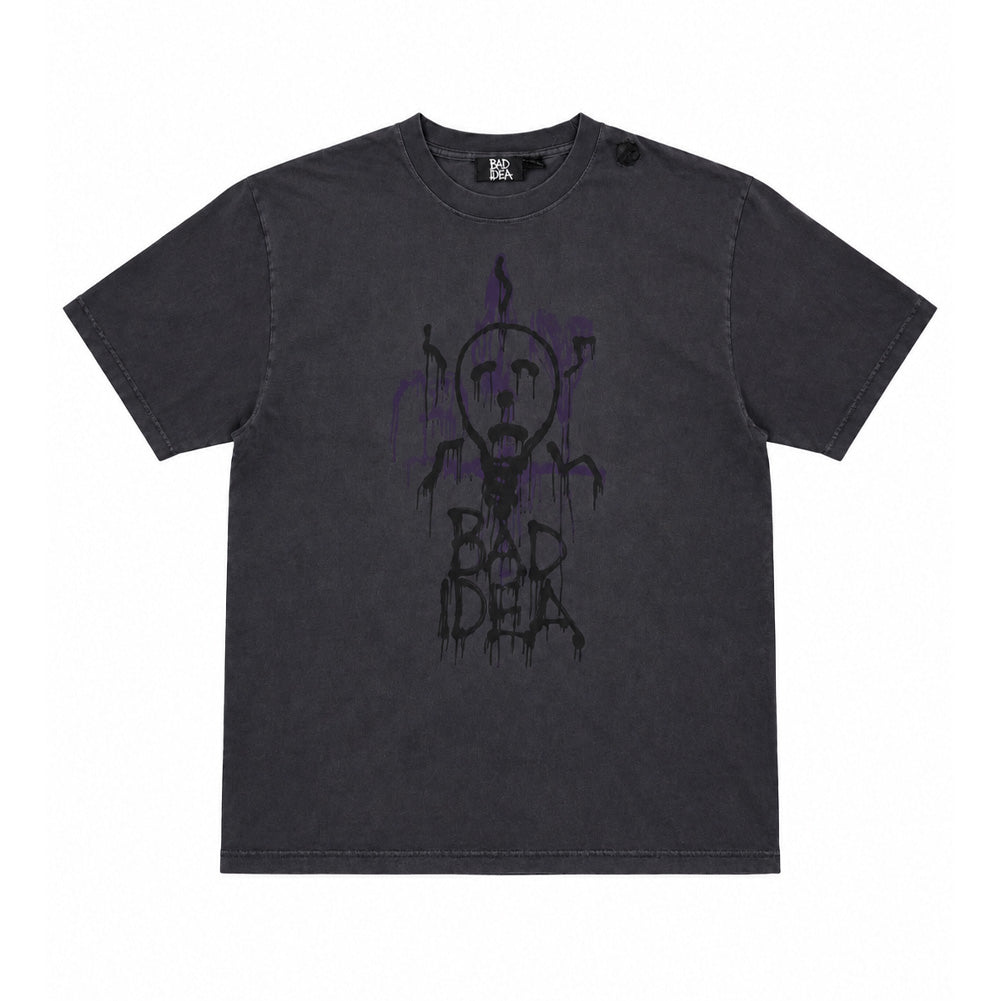 Front flat lay studio view of the Vans OTW x Chito T-Shirt in vintage washed black, showcasing a relaxed heavyweight cotton skate silhouette with a ribbed crewneck, centered by artist Chito's signature dripping airbrush graphic featuring an eerie lightbulb pup character against muted purple spray shadows above drippy "BAD IDEA" graffiti typography.