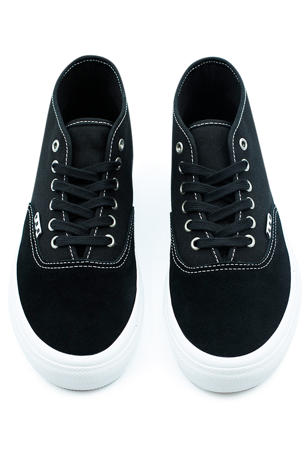 Top view of Vans Skate Authentic Mid Black/White sneakers featuring metal eyelets, reinforced lacing system, PopCush cushioning, and durable skateboarding construction.