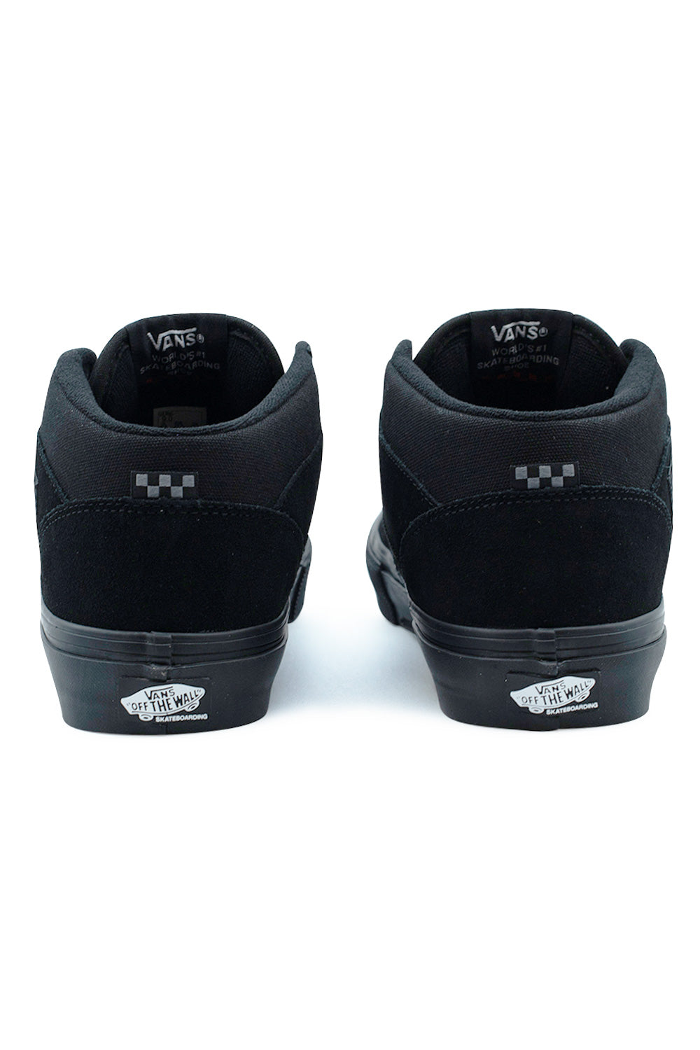Rear view of the heels of the Vans Skate Half Cab shoes in Black / Black, highlighting the padded black ankle collar liners, subtle black-and-grey checkerboard flag tags, vertical suede heel strips, and black-on-white rubber Vans Skateboarding Off The Wall license plates on the dark foxing tape.