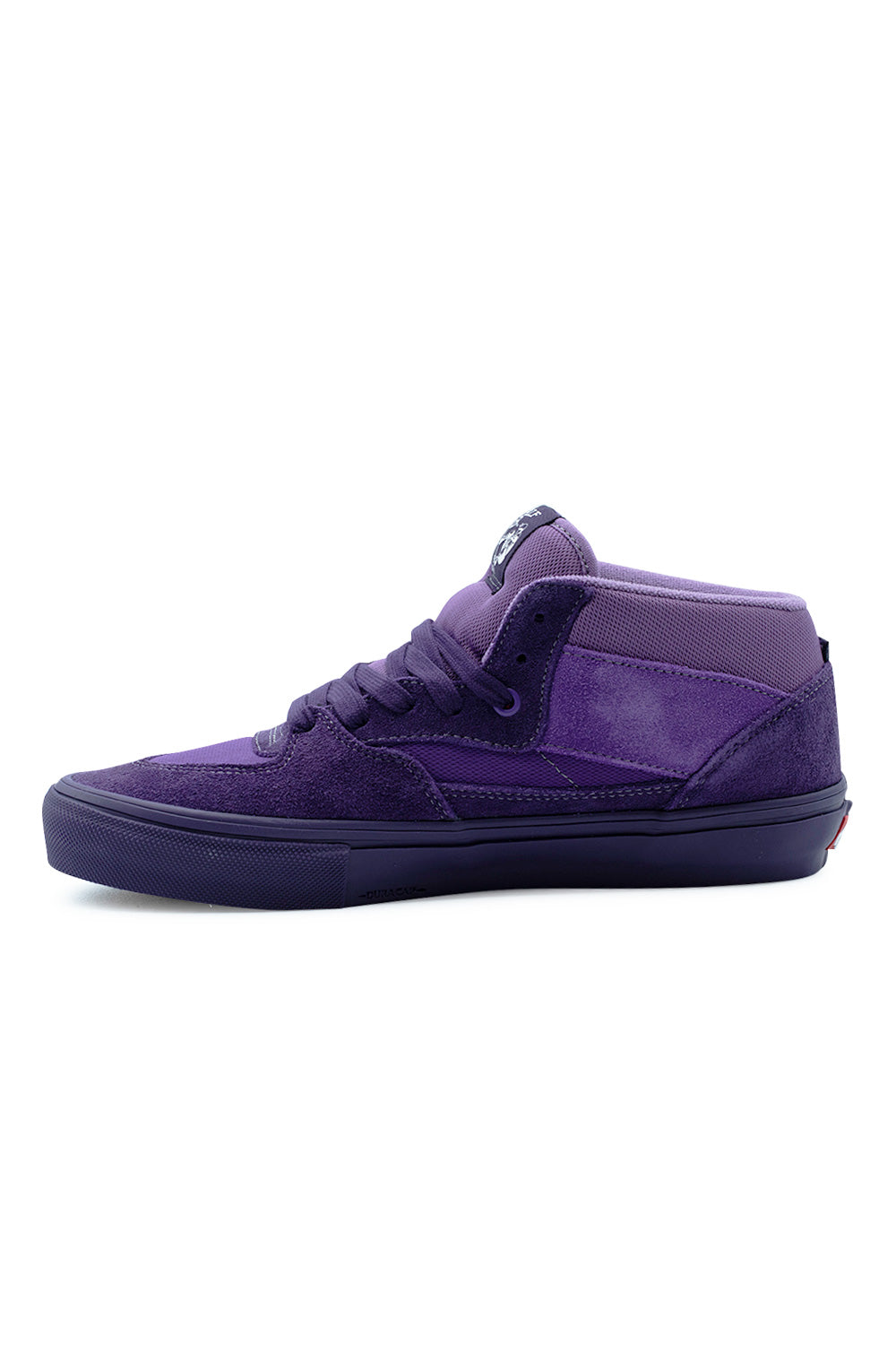 Medial side profile view of the Vans Skate Half Cab shoe in Purple Licorice, displaying the multi-panel construction of breathable mesh and rough-out suede, embossed Duracap rubber underlay logo on the vulcanized toe wrap, and tonal purple eyelet reinforcements.