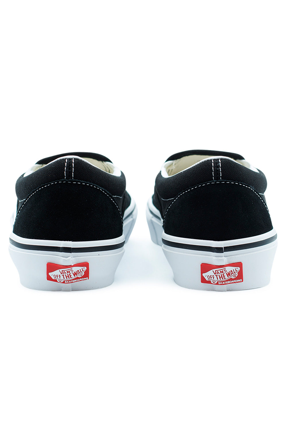 Rear angle Vans Skate Slip On Black White classic skate sneakers with Off The Wall heel tab, padded collar, DURACAP reinforced construction