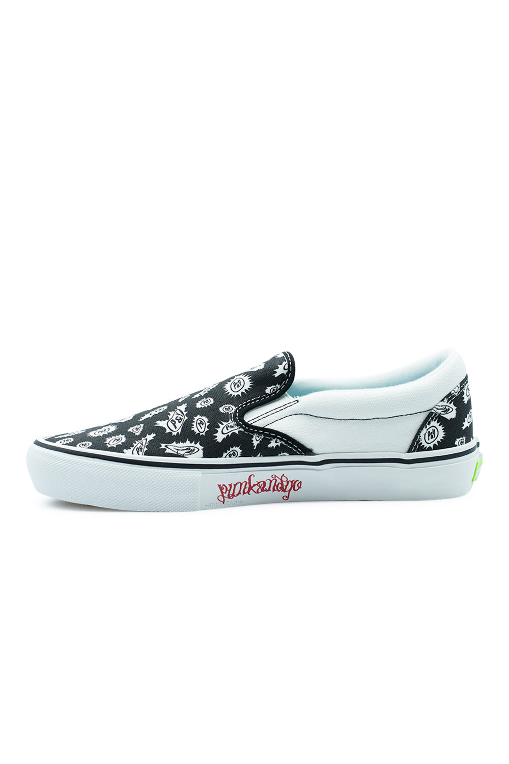 Medial inner arch view of the Vans X Punk And Yo Skate Slip-On sneaker, showing the white canvas midfoot quarter, black patterned toe box, elastic tongue gores, textured toe bumper, and red script "Punkandyo" logo stamped along the white vulcanized midsole