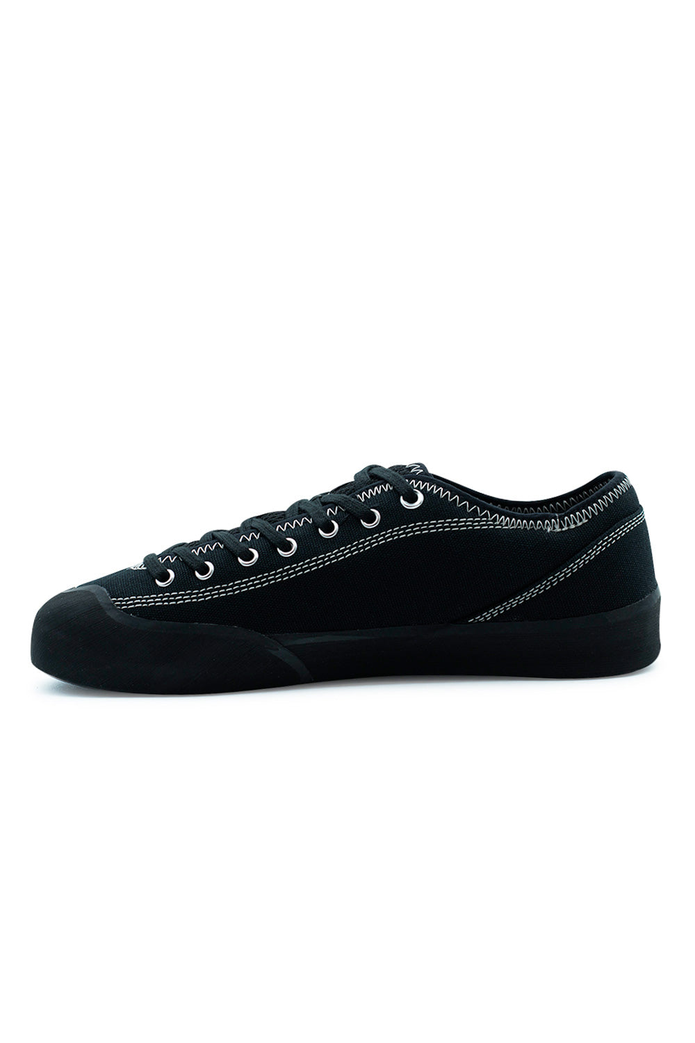 Village PM 1.30PM Black Natural Black skateboard sneaker lateral angle displaying asymmetrical upper design, flexible rubber glove construction and precision skate fit