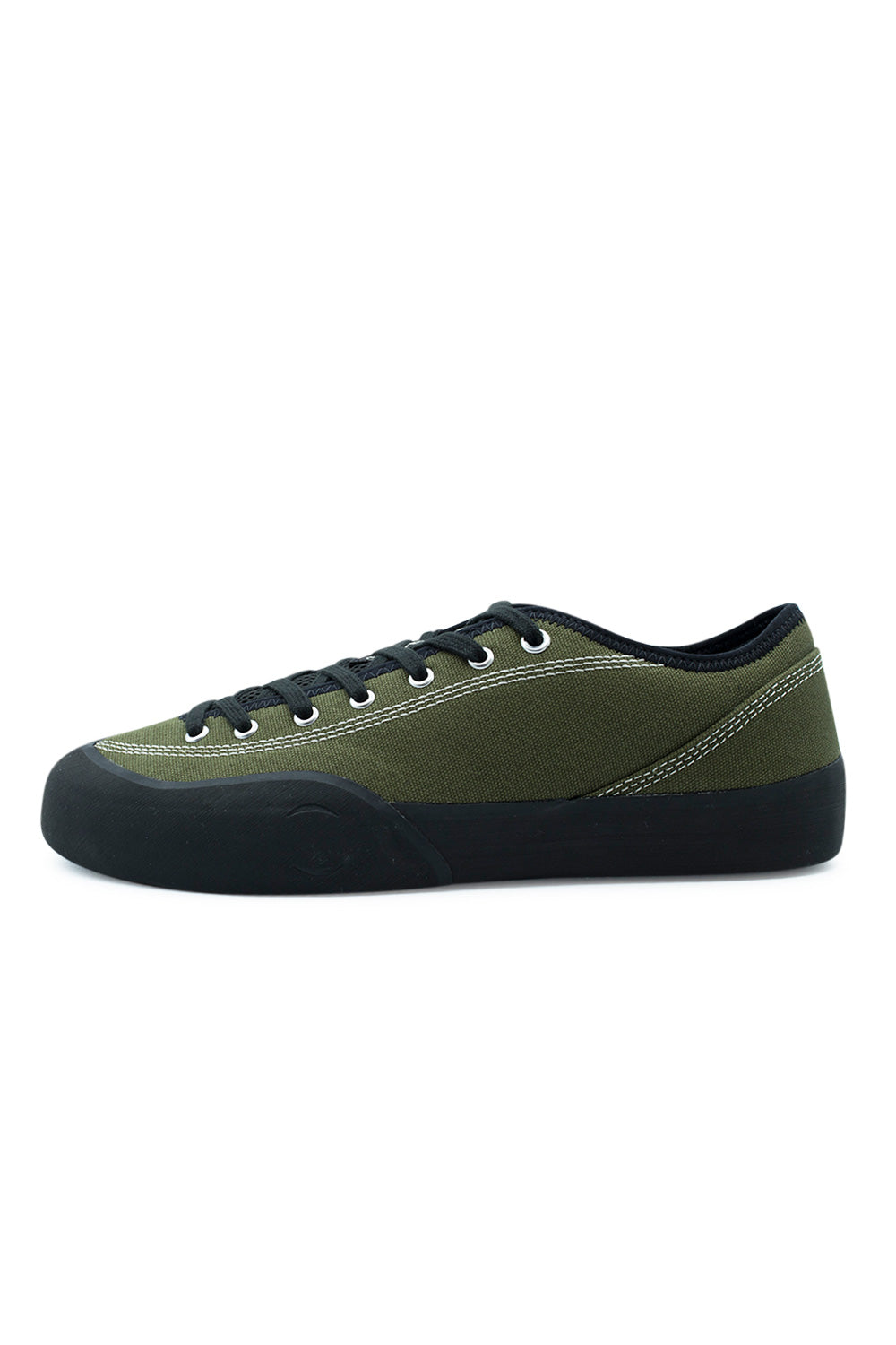 Lateral profile view of the Village PM 1.30PM skate shoe in Olive and Natural Black, showcasing the durable olive-green canvas upper accented with contrast white double-needle stitching, silver metal eyelets, black flat laces, and a hand-wrapped black climbing rubber rand that curves high over the toe box, ollie area, and heel counter.