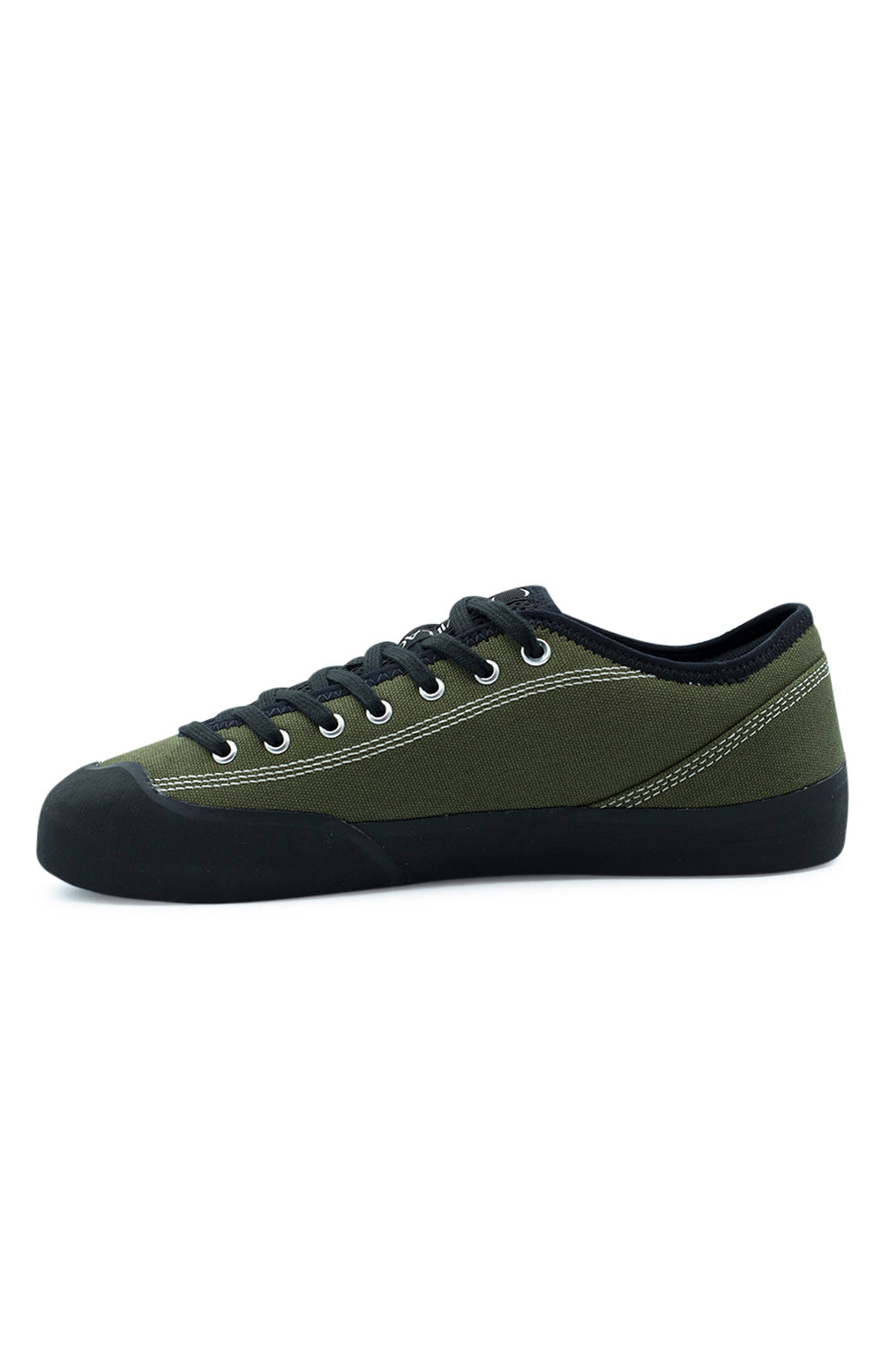 Medial arch profile view of the Village PM 1.30PM sneaker, highlighting the clean inner olive-drab canvas side panel, precise white reinforcement stitching, silver lace eyelets, black flat laces, and the contoured black climbing rubber wrap extending under the midfoot arch.