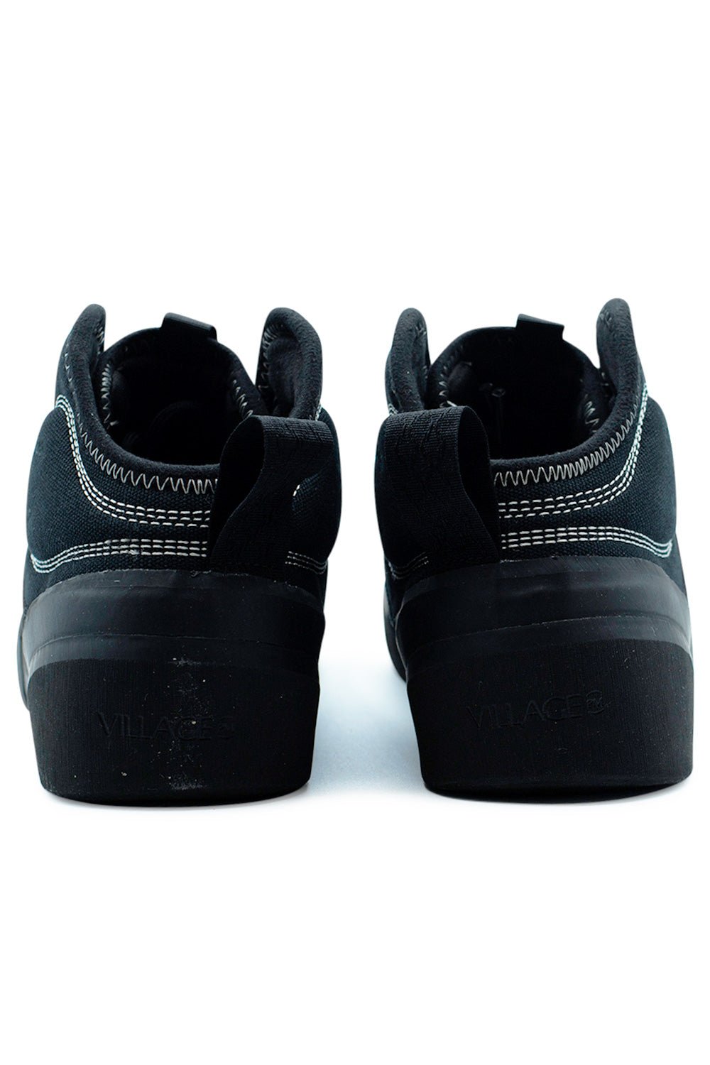 Rear view of Village PM 1PM Mid Black Natural Black mid-top skate sneakers featuring padded ankle collar, heel pull tabs and durable canvas heel panel for added skateboarding support