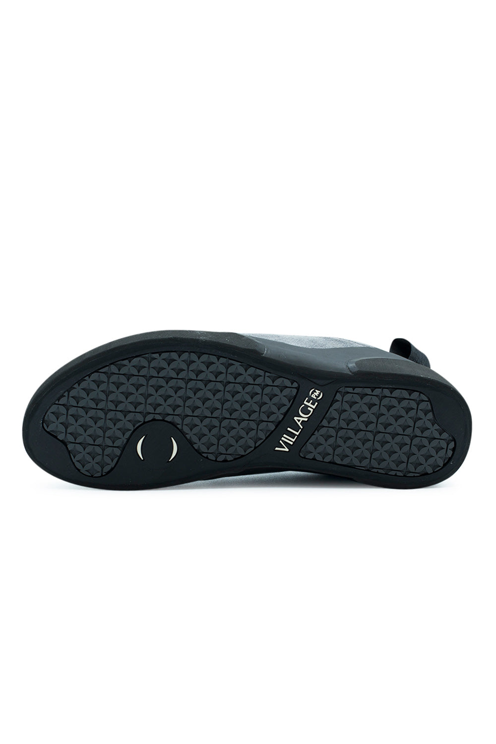 Full bottom view of the black rubber outsole on the Village PM 1PM, detailing the repeating geometric circular star traction tread pattern, integrated arch pivot point, and white "VILLAGE PM" brand lettering debossed into the midfoot bridge[cite: 94].
