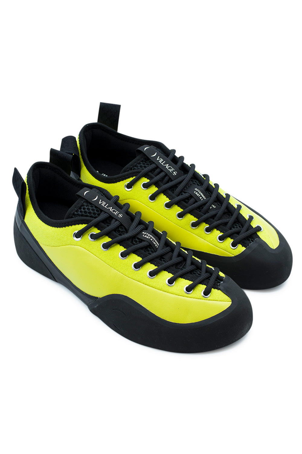 Elevated three-quarter studio perspective of the Village PM 1PM in Lime LTR / Natural Black, highlighting the technical hybrid of outdoor rock climbing approach footwear and rugged skateboard shoe design with vibrant neon leather and high-coverage black rubber foxing.