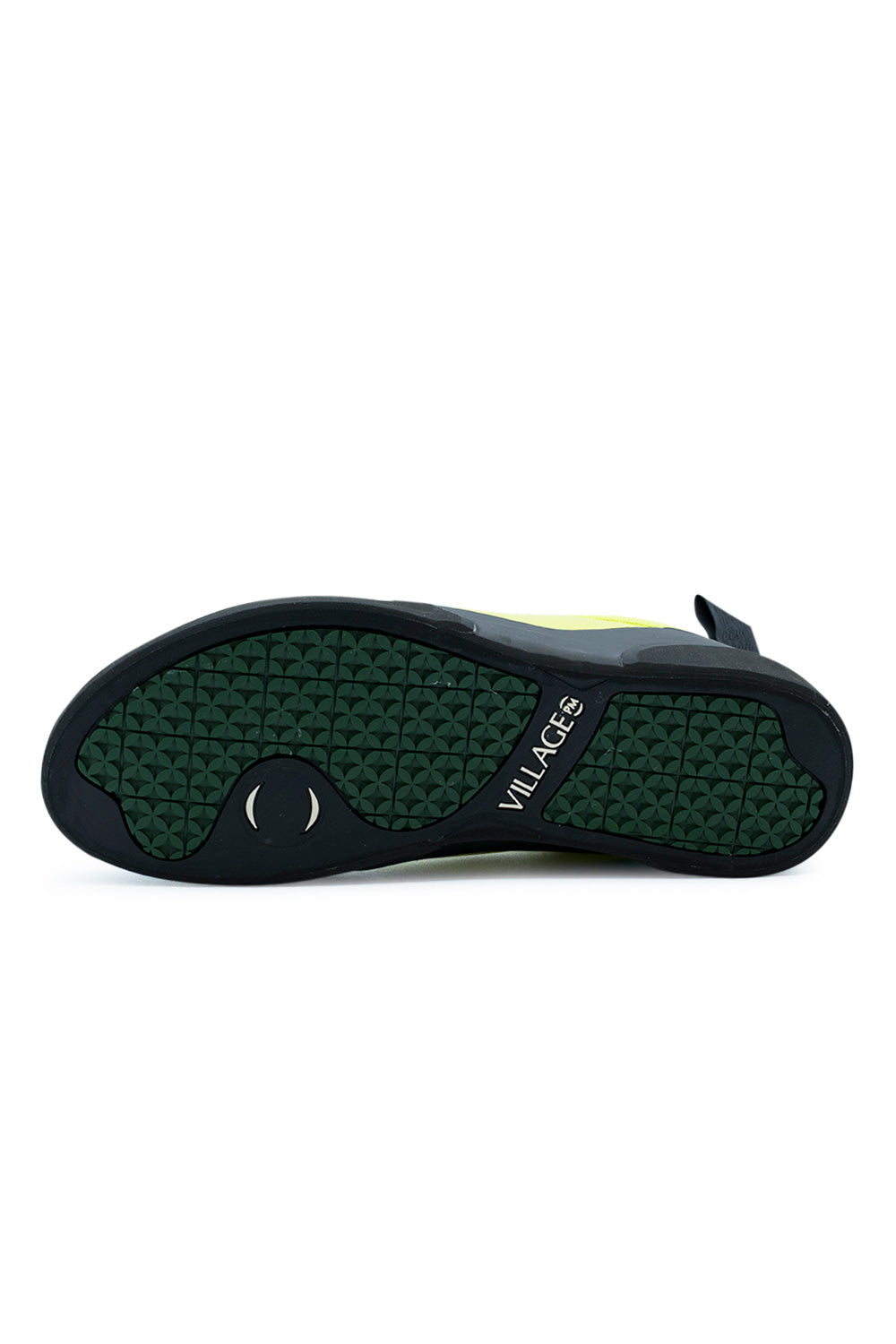 Full bottom perspective of the two-tone rubber outsole on the Village PM 1PM, featuring deep forest green inset tread with repeating geometric circular star traction lugs, a forefoot pivot spot, a black climbing rubber perimeter rand, and debossed white "VILLAGE PM" branding across the midfoot arch.