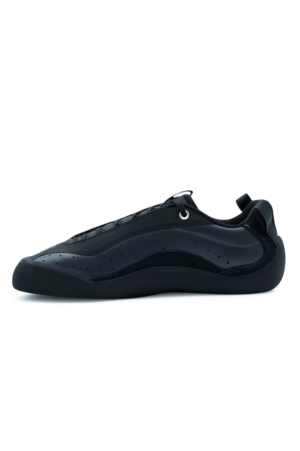 Lateral profile view of the all-black Village PM 2PM skate shoe in Anthracite and Natural Black, featuring a matte perforated anthracite synthetic leather upper, integrated black rubber lace-shield overlay, silver top eyelet, black webbing heel pull tab, and a hand-wrapped black sticky climbing rubber rand protecting the forefoot and ollie friction zones.