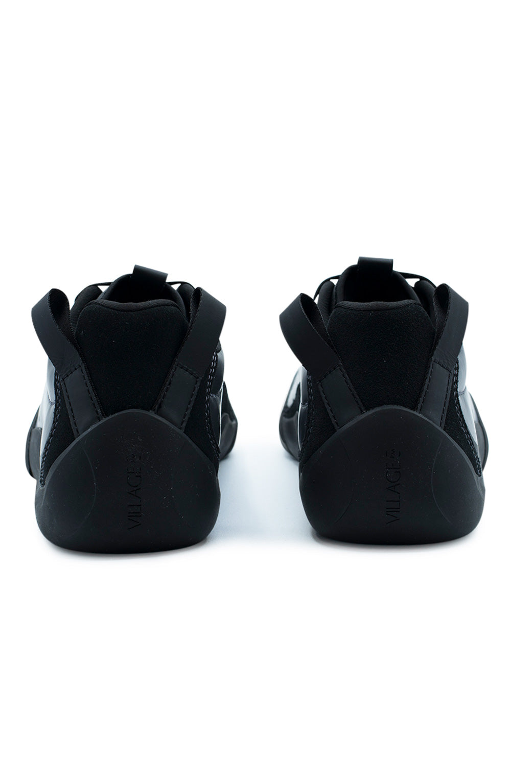 Rear view of the heels of the Village PM 2PM sneakers, displaying the seamless black climbing rubber heel counters embossed with vertical "VILLAGE" branding, padded black low-cut collars, and angled dual heavy-duty black webbing pull loops.