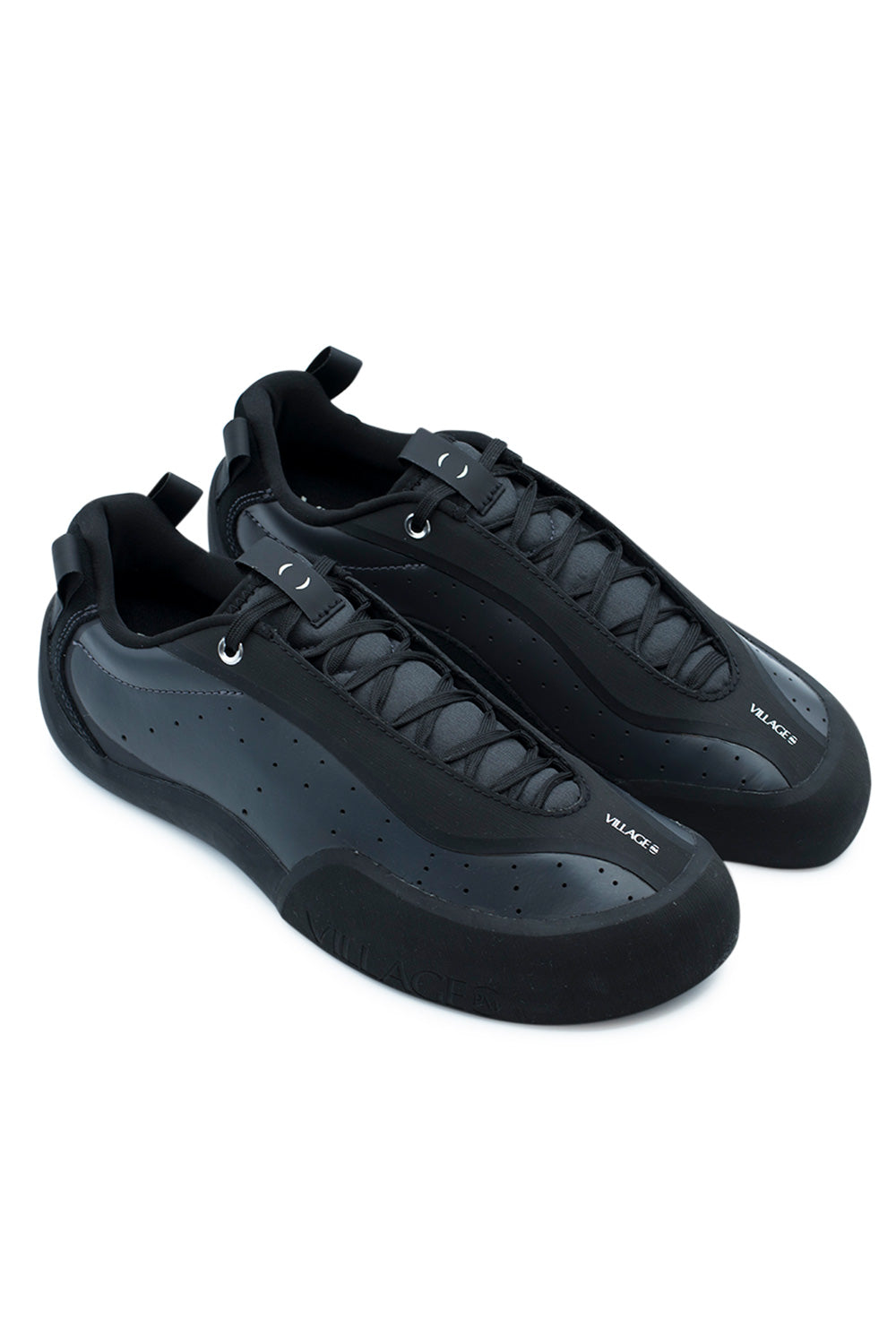 Elevated three-quarter studio perspective of the Village PM 2PM in Anthracite / Natural Black, highlighting the technical rock-climbing-inspired skate shoe construction, griptape-shielded lacing system, angular toe silhouette, and clean monochrome styling.