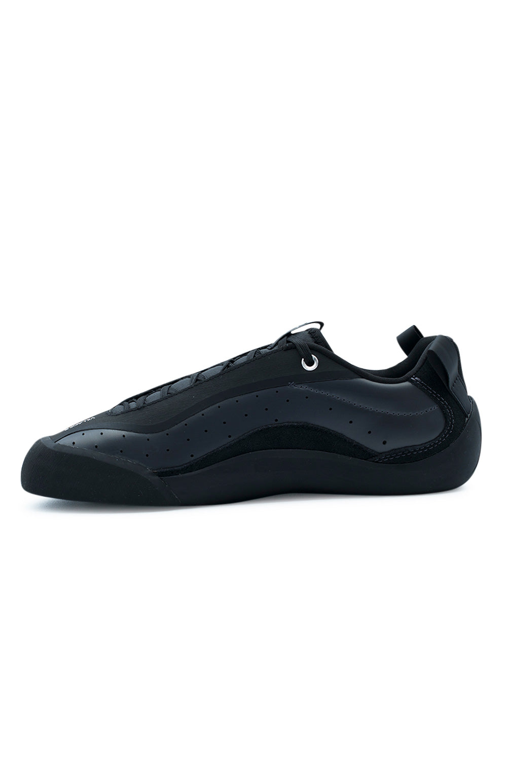 Medial arch profile view of the Village PM 2PM shoe, detailing the clean inner matte anthracite synthetic quarter with ventilation pinholes, low padded ankle collar, rear pull tab, and the continuous molded black climbing rubber rand curving under the midfoot.
