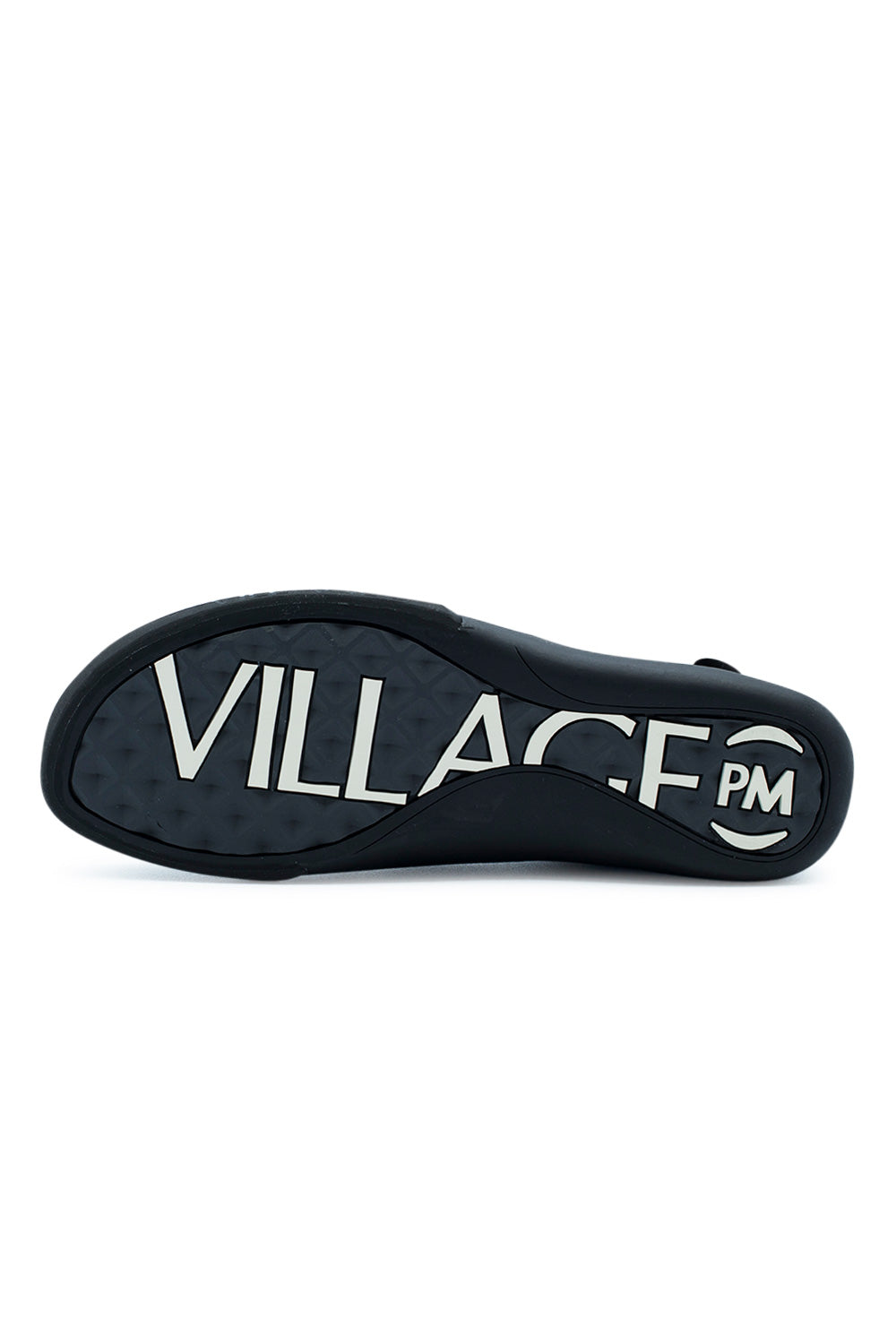 Full bottom view of the black rubber outsole on the Village PM 2PM, featuring charcoal diamond-lug traction tread stamped with bold, oversized white "VILLAGE PM" brand lettering spanning the midfoot arch and surrounded by the textured black rubber wrap.