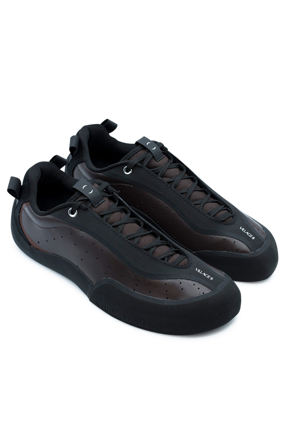 Elevated three-quarter studio perspective of the Village PM 2PM in Maroon / Natural Black, highlighting the technical rock-climbing-inspired skate shoe silhouette, protected lacing system designed to prevent griptape tears, and seamless rubber wrap construction.