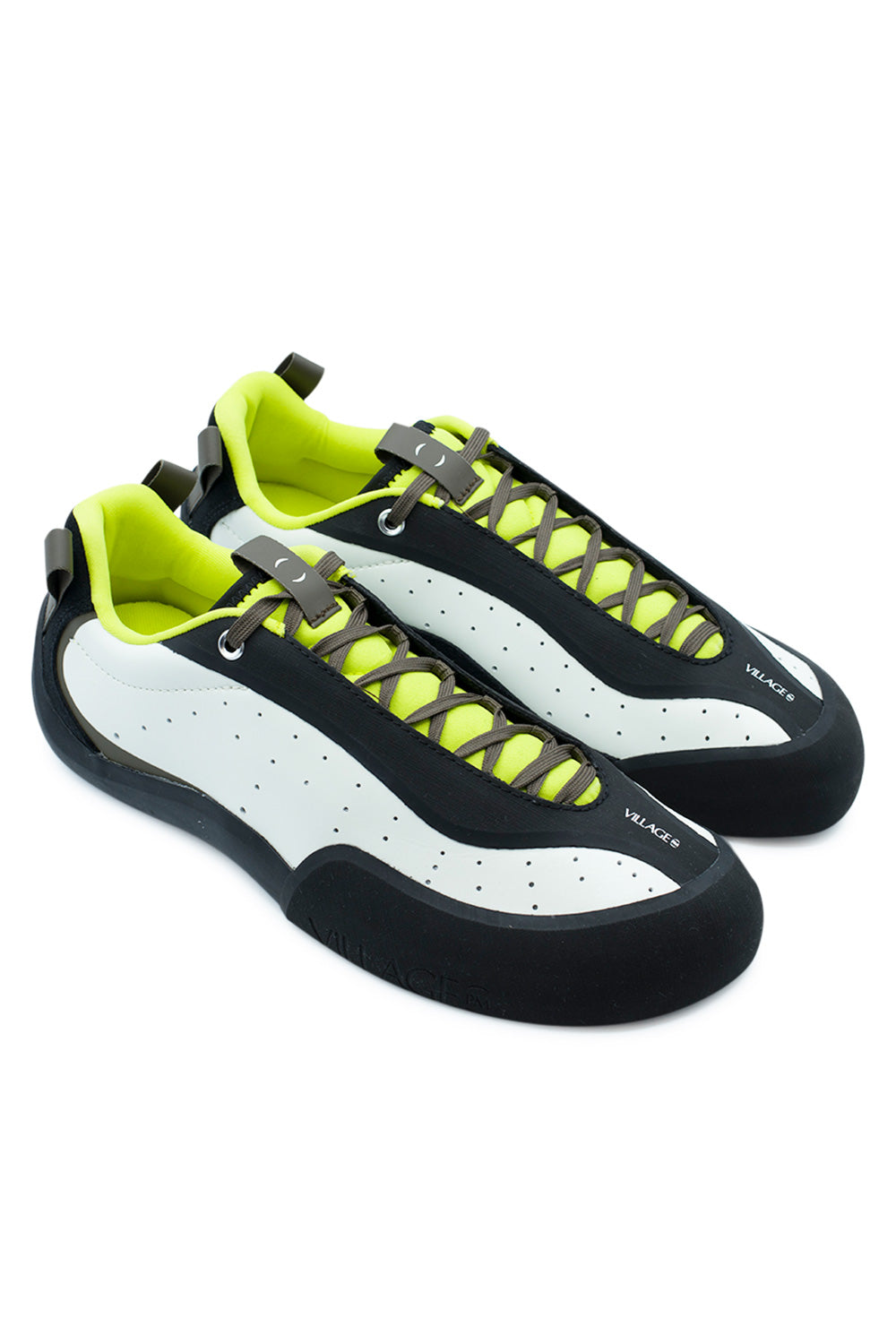 Elevated three-quarter studio view of the Village PM 2PM in White / Lime / Natural Black, highlighting the technical rock-climbing-inspired skate shoe design, griptape-shielded lace layout, angular toe box profile, and striking high-contrast color blocking.