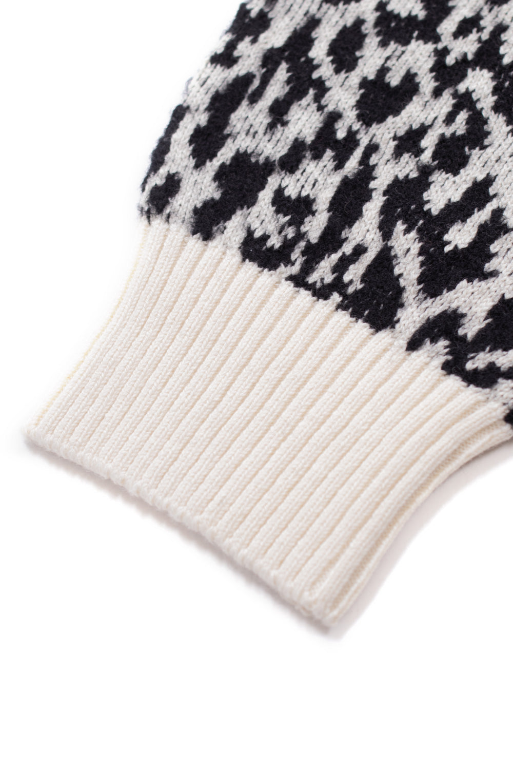 Wacko Maria side label tag on white leopard jacquard sweater, Guilty Parties branding detail on high end streetwear knit