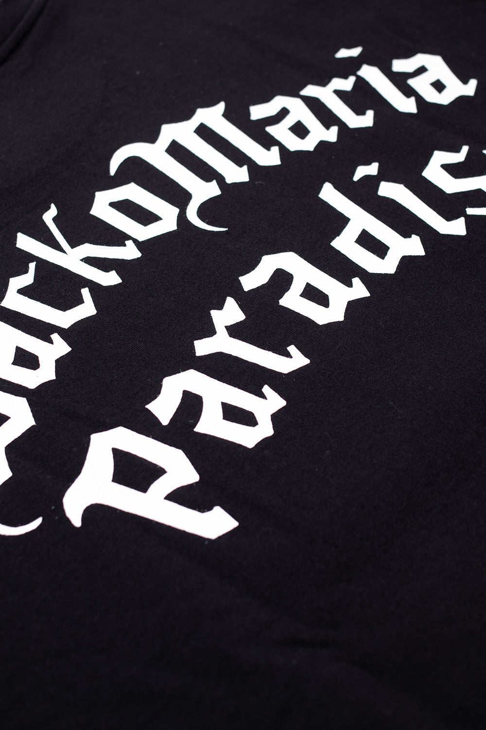 close up of Wacko Maria Paradise back print on black heavyweight t-shirt, vintage style graphic lettering on premium cotton fabric