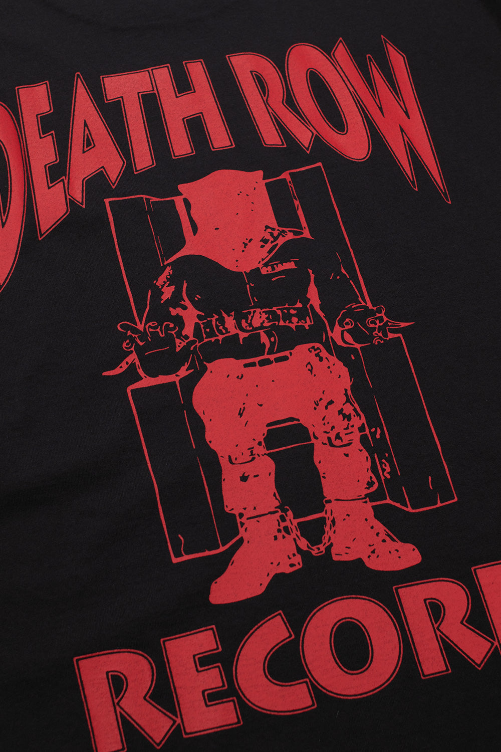 Close-up detail of the iconic red printed Death Row Records electric chair logo on the back of the black cotton t-shirt.