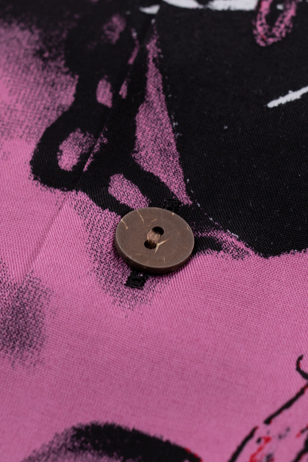 Macro shot of wooden button on Wacko Maria Terrifier Hawaiian shirt Type-3, high-quality rayon construction, seamless graphic alignment across button placket