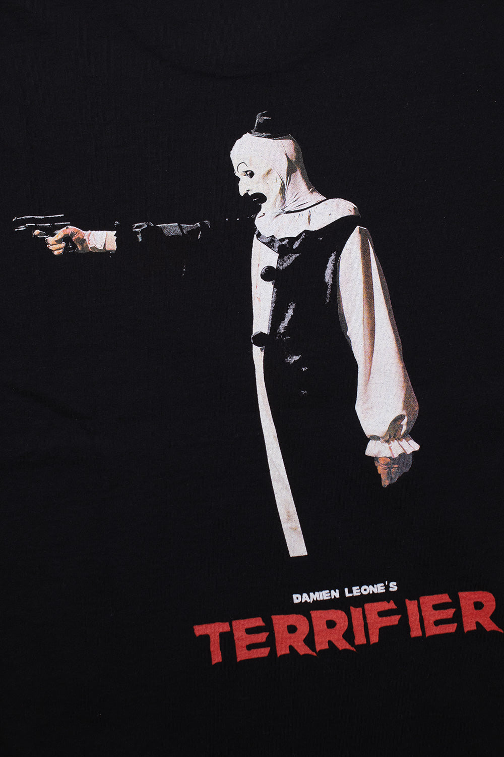 Close-up of Art the Clown gun scene graphic with Terrifier logo on Wacko Maria long sleeve T-shirt, dark horror aesthetic Damien Leone film merchandise streetwear