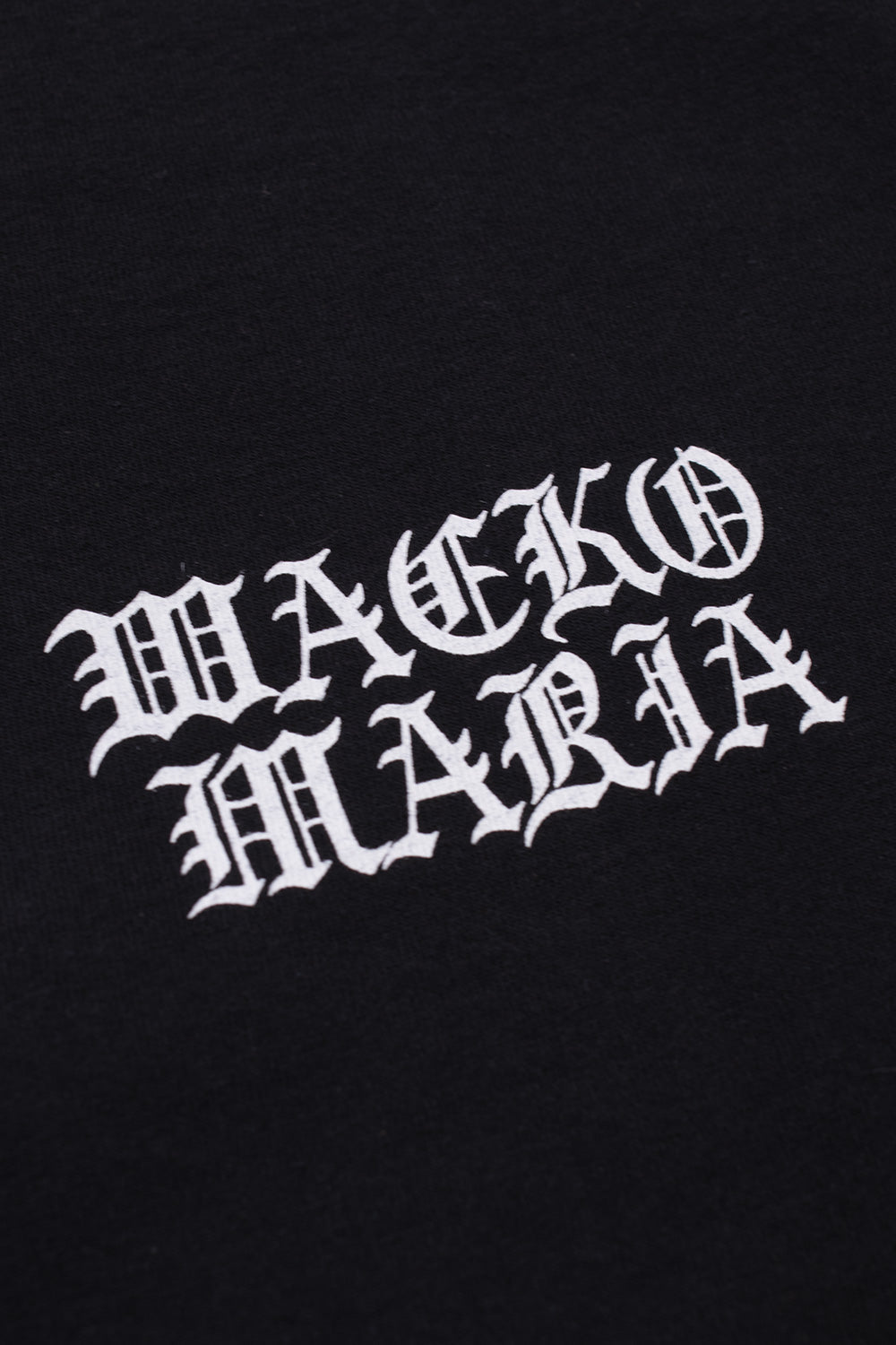 Detailed Wacko Maria gothic logo print on left chest of black long sleeve T-shirt, high-quality heavyweight cotton Japanese fashion collaboration Terrifier