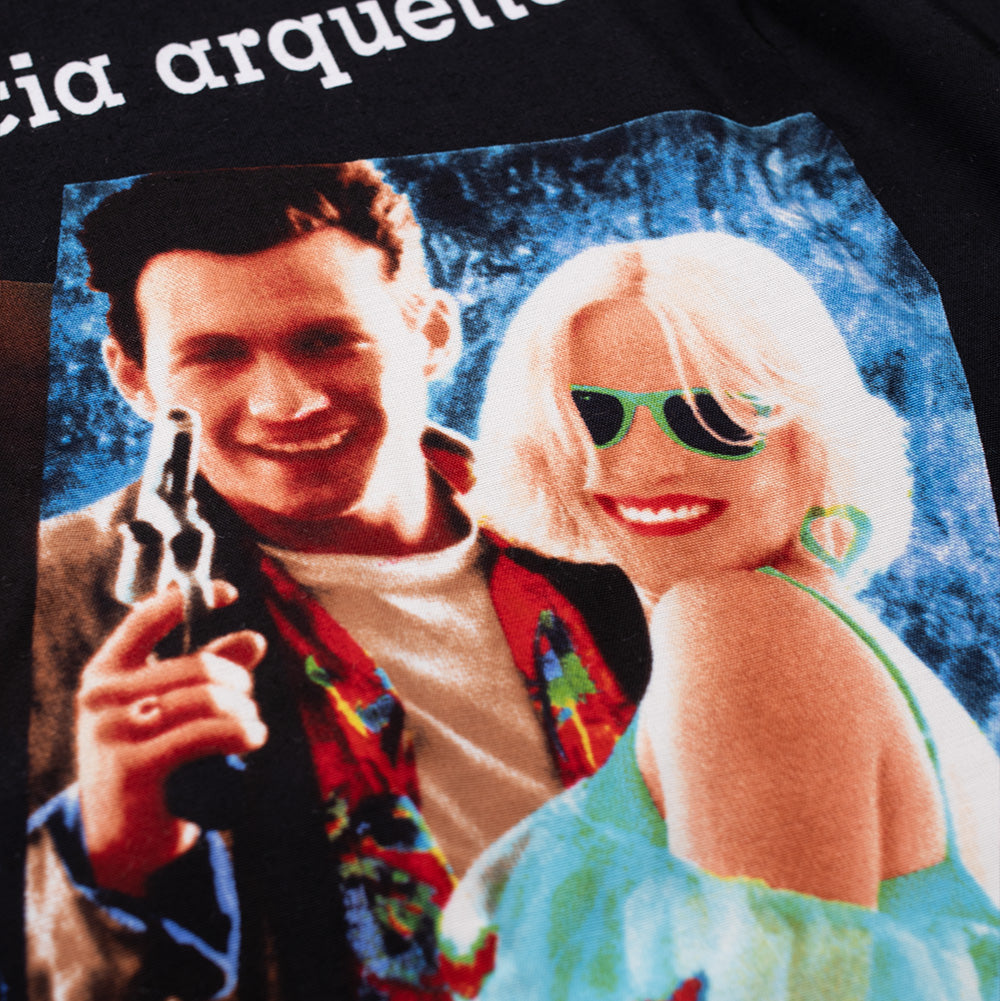 Detailed close-up shot focusing on the lead characters Clarence and Alabama within the back print of the Wacko Maria x True Romance Hawaiian Shirt, highlighting the halftone screen-printed photographic details and retro color grading applied directly to the woven black shirt.